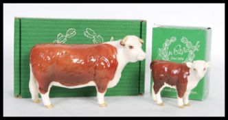 Two Beswick ceramic figurines of Hereford cows to include a Bull Cow and Calf painted in brown and