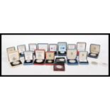 A selection of boxed proof coins to include eight boxed silver pound coins dating from the 1980's,