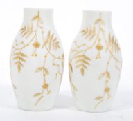 A pair of 19th Century Victorian opaline glass milk glass vases having hand gilded decoration