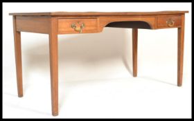 A 20th Century mahogany library table desk having faux red leather writing skiver with drawers