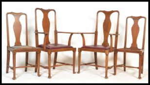 A set of 4 Edwardian oak Queen Anne dining chairs being raised on cabriole legs with pad feet and