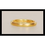 A 22ct gold wedding band ring having hallmarks for London dating 1939 and stamped W.W.Ld. Weight 3.