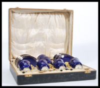 A set of 20th Century Coalport coffee cups and saucers having gilt interiors and cobalt blue