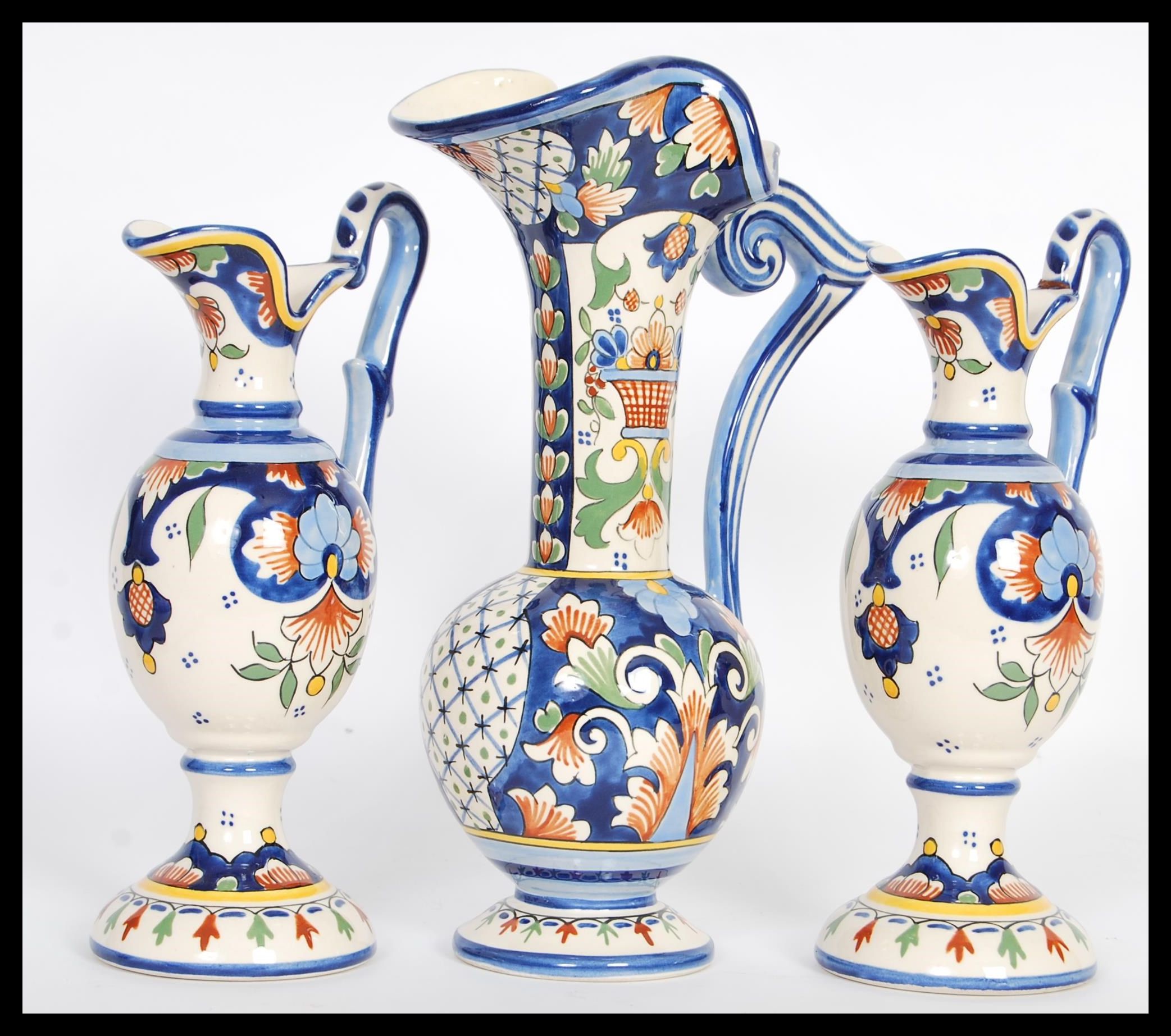 A set of three 20th Century Faience graduating baluster jugs raised on circular bases with bulbous