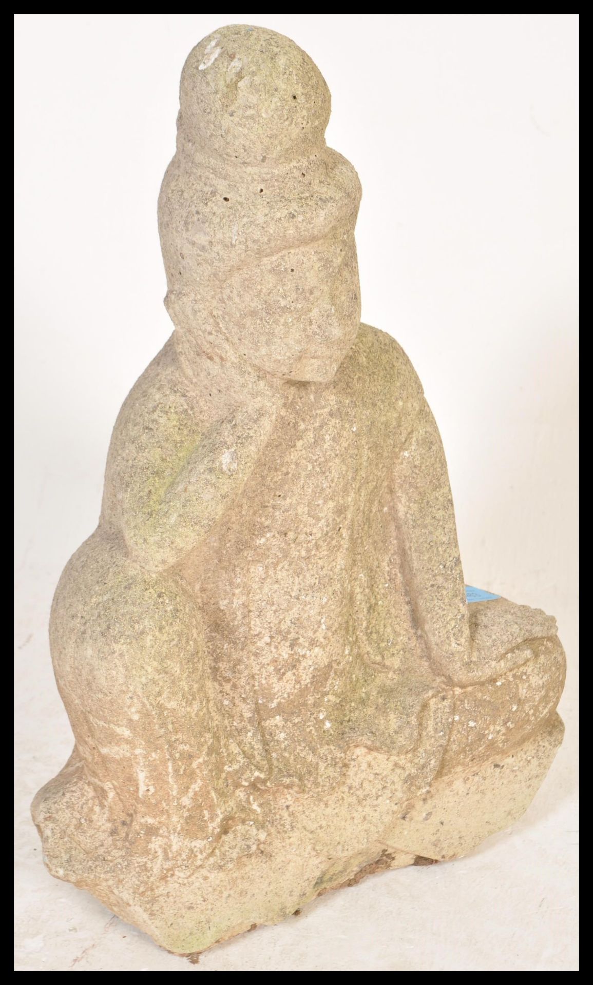 A well weathered garden reconstituted stone figure