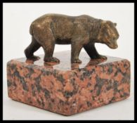 A vintage early 20th Century Art Deco bronze / bronzed figurine of a bear cub raised on marble