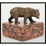 A vintage early 20th Century Art Deco bronze / bronzed figurine of a bear cub raised on marble