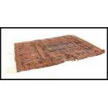 A 19th Century Persian ISlamic floor carpet rug having a deep pile wool red ground with hand woven