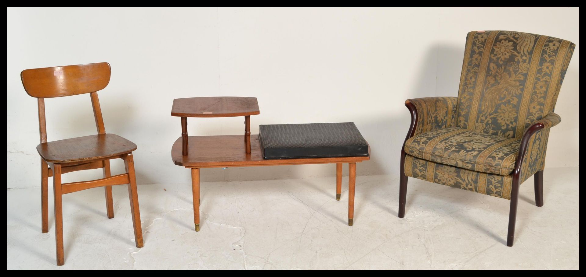 A retro 20th Century Parker Knoll armchair together with a retro teak wood telephone table and a