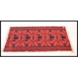 A vintage 20th Century Eastern European Russian / Albanian floor carpet rug having a red ground with