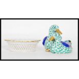 A 20th Century Herend Hungary figurine depicting two ducks having hand painted decoration and gilt