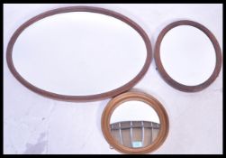 A collection of three 20th Century wall mirrors da