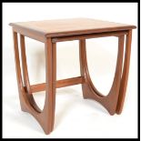A vintage retro 20th Century G-Plan teak wood nest of tables raised on shaped supports with square