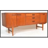 A retro 20th Century teak wood sideboard / credenza of Danish influence, having a central bank of