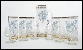 A retro 20th Century glass lemonade set consisting of a tall jug with six matching hi-ball glasses