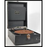 A vintage early 20th Century portable picnic gramophone by Linguaphone in black leatherette case.