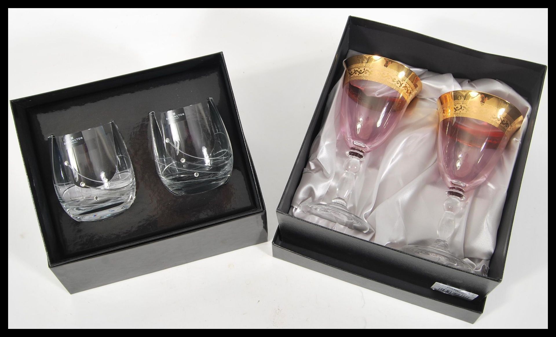 A boxed set of Dartington Glitz Swarovski crystal set drinking glasses complete in original box