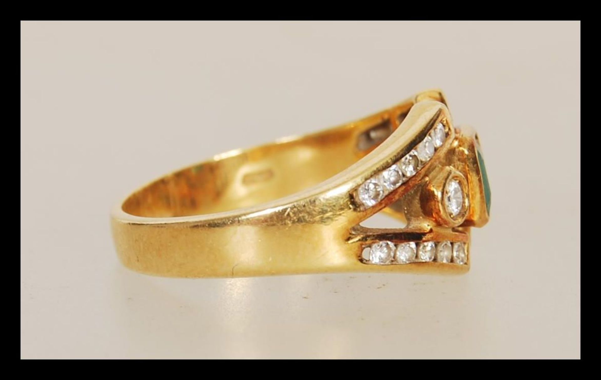A stamped 750 18ct gold ladies dress ring set with a square cut emerald within a split shank - Image 2 of 5