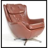 An original 1960's retro vintage button back swivel egg type chair / armchair being raised on a five