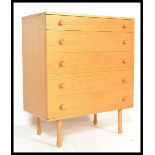 A vintage / retro 20th Century teak wood chest of five graduating drawers raised on tapering