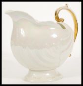 An early 20th Century Shelley Late Foley large wash jug in the form of a claw shall having gilded