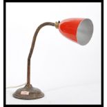 A vintage retro 20th Century industrial gooseneck table desk lamp raised on stepped circular base