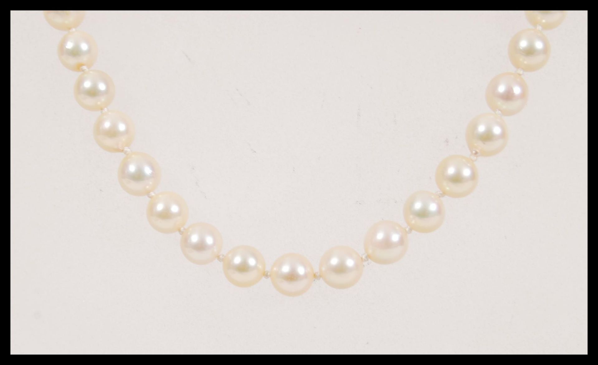 A 20th Century vintage string of cultured pearls approx 60 pearls on a knotted string, having a