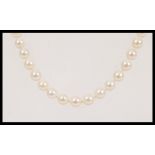 A 20th Century vintage string of cultured pearls approx 60 pearls on a knotted string, having a