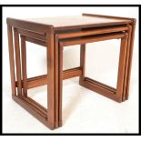 A 1970's G-Plan teak wood nest of tables having shaped legs united by stretchers with graduating