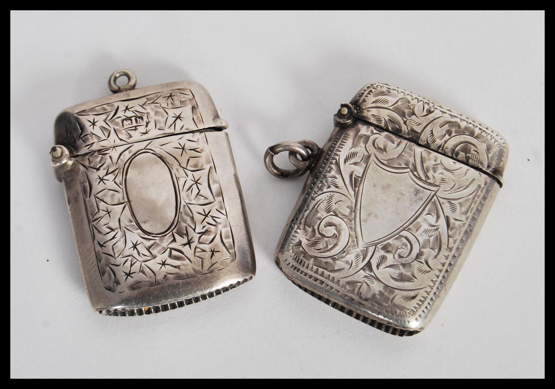 Two early 20th Century hallmarked silver vesta match cases having engraved scrolled decoration