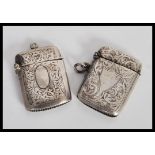 Two early 20th Century hallmarked silver vesta match cases having engraved scrolled decoration