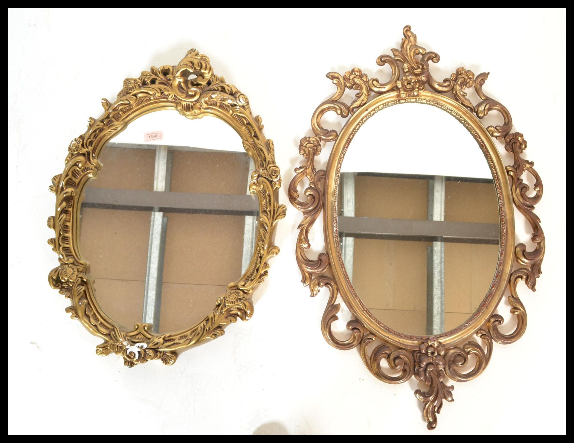 Two antique style 20th Century ornate glass wall mirrors having faux food gilt ormolu scrolled