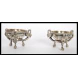 A pair of early 20th Century silver plated open table salt cellar condiments raised on tripod