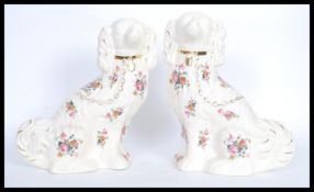 A pair of 20th century ceramic KLM Staffordshire dogs having flower decoration and gild lead and