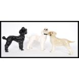 A group of three vintage 20th Century ceramic dogs to include a black and white poodle and a