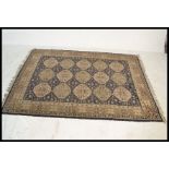 A large 20th century Persian floor carpet Bokhara rug having a blue ground with geometric borders