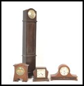 A collection of clocks dating to the early 20th Century to include an oak cased grandmother clock,
