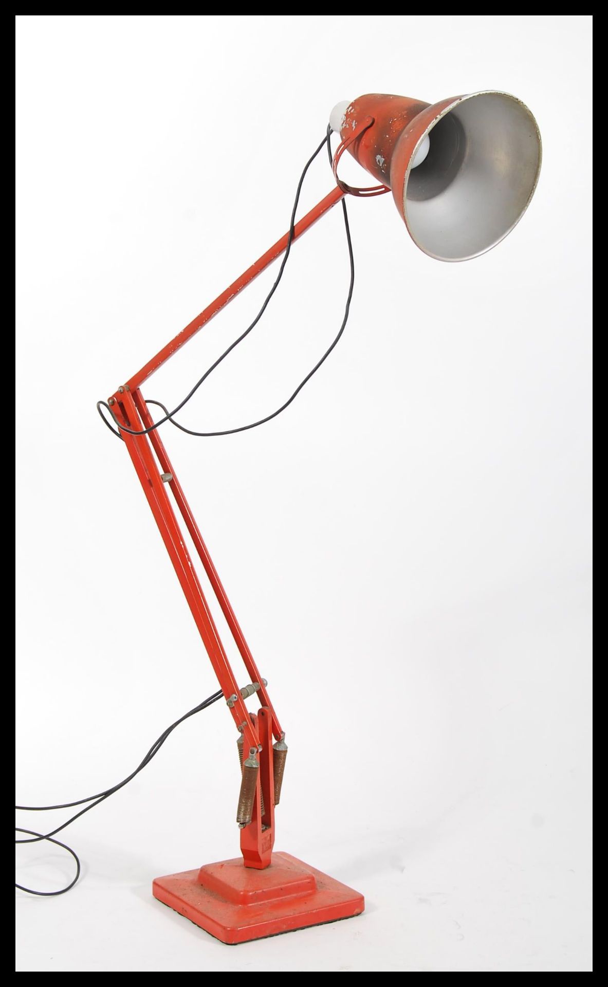 A 1940's Industrial pre-war Herbert Terry anglepoise lamp, raised on a cast metal two step base with