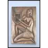 A 20th Century wall hanging bronzed plaque depicting a seated partially naked lady playing a lyre in