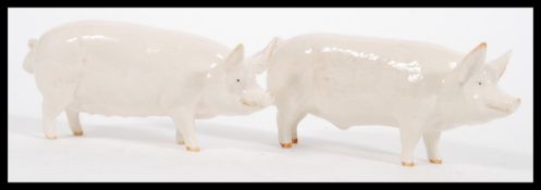 A pair of vintage 20th Century Beswick ceramic figurines of pigs / boar comprising of a Champion