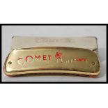 A rare vintage 20th Century M Hohner Comet space age harmonica having a gilt brass body with red