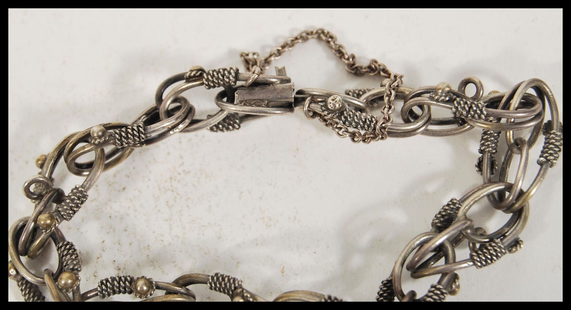 A stamped 800 silver bracelet having decorative links with rope chain detailing with a charm - Image 4 of 4
