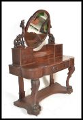 A 19th Century Victorian mahogany Duchess dressing table raised on scrolled legs with oval swing