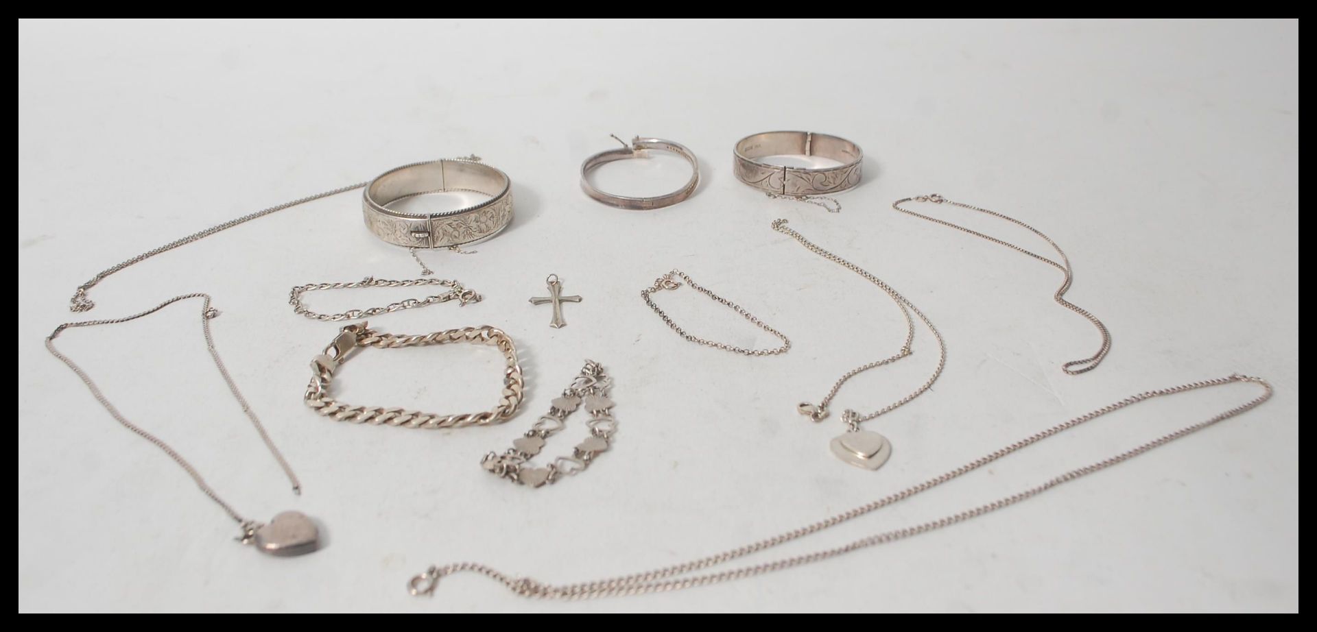 A collection of silver jewellery to include various silver necklaces, silver bangles, silver