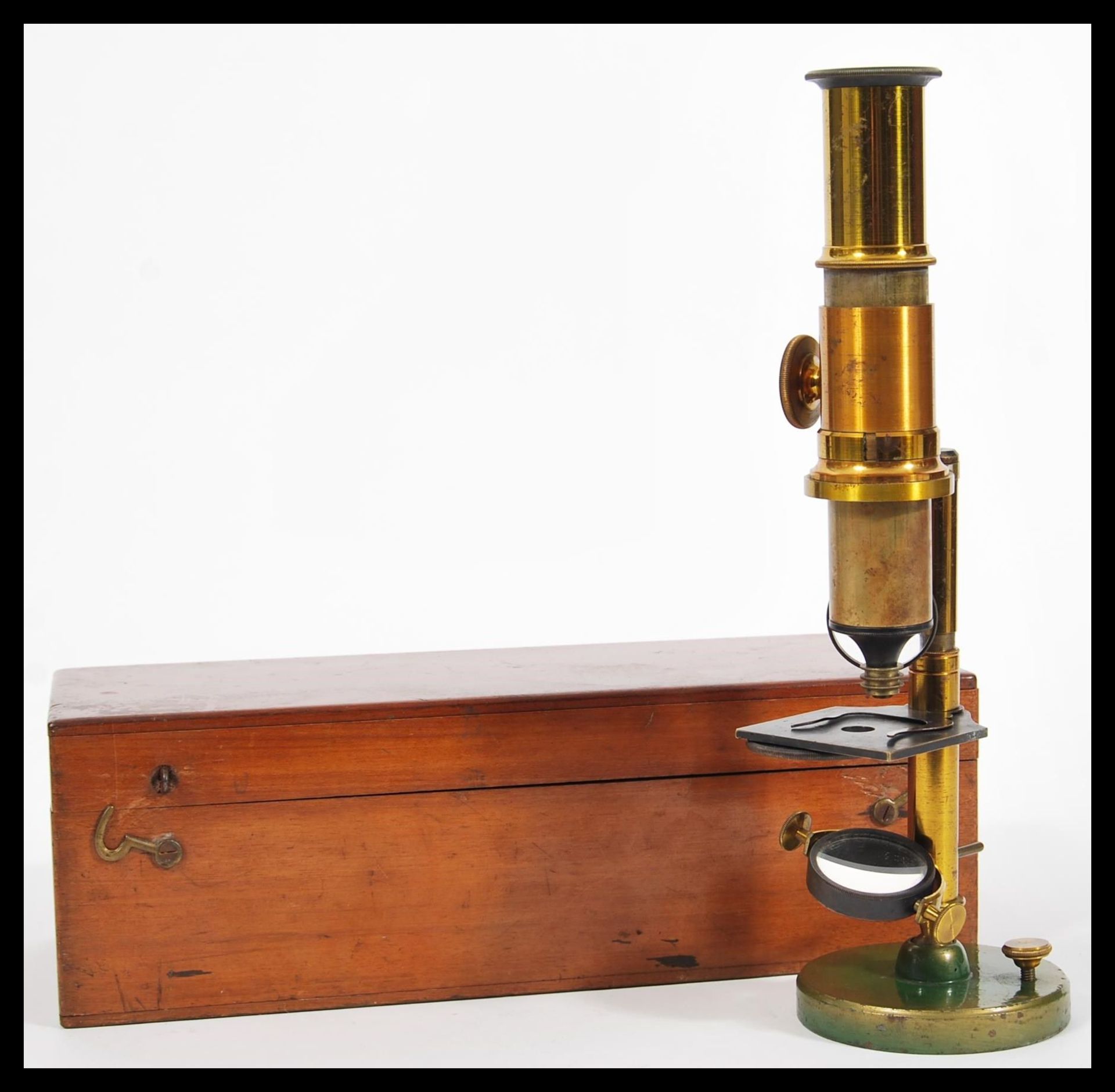 A 19th Century Victorian brass microscope on circular swivel base complete in original box with JD