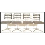 A set of four vintage retro 20th Century dining chairs raised on a central tubular column with