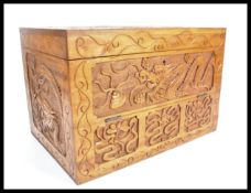 A 20th Century Chinese carved box wood writing box / slope having carved dragons to the exterior and
