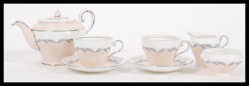 A vintage 20th Century Aynsley tea for two service having a pale pink and white floral garland