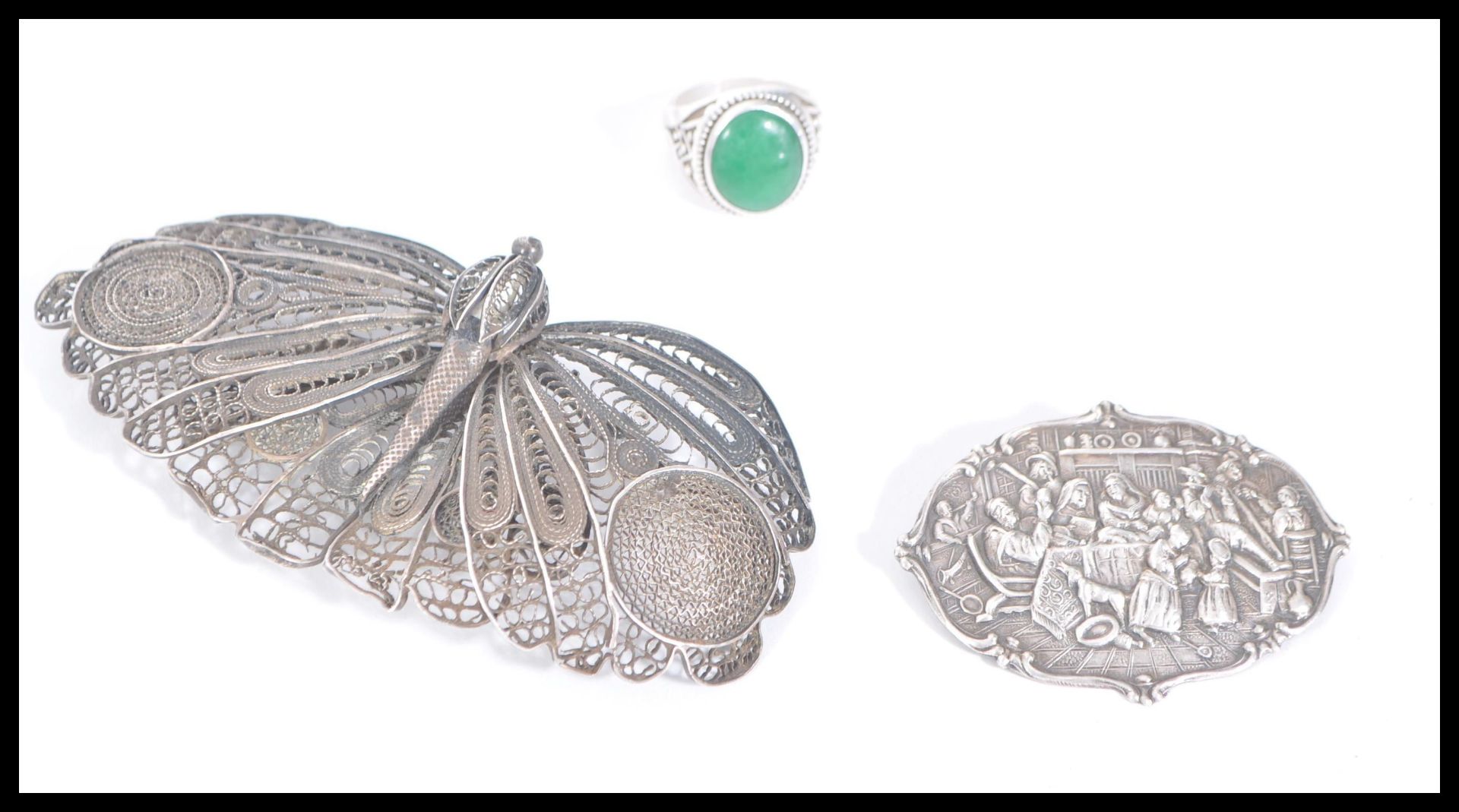 A large antique silver filigree brooch in the form of a butterfly along with a silver brooch