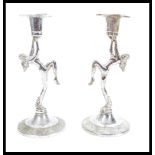 A pair of vintage retro 20th Century Art Deco style chrome candlesticks raised on stepped circular